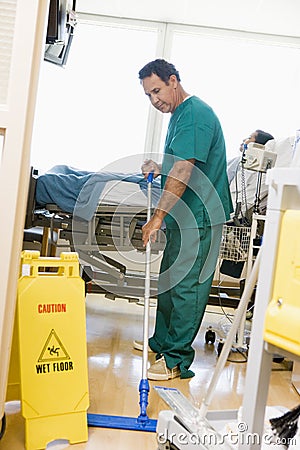 An Orderly Mopping The Floor In A Hospital Ward Stock Photo