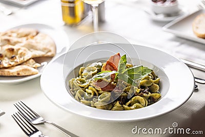 Orecchiette con pesto genovese e speck tirolese, Italian pasta with pesto and Tyrolean bacon Stock Photo