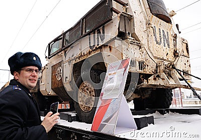Orel, Russia, February 25, 2019: Syrian Break - trophy exhibition train of Russian Defence Ministry. Serviceman in uniform taking Editorial Stock Photo