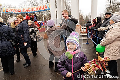 Orel, Russia - March 13, 2016: Maslenitsa, Pancake festival. Girl with straw Lady Maslenitsa doll and people dancing Editorial Stock Photo