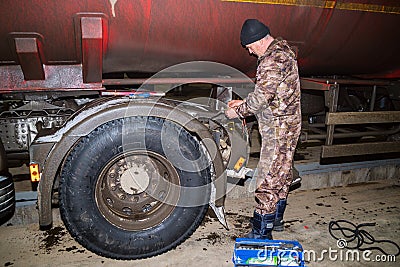 A car electrician repairs the wiring of a truck Editorial Stock Photo