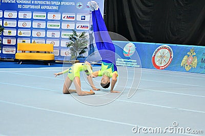 Orenburg, Russia, December 14, 2017: A girl and a young man compete in sports acrobatics Editorial Stock Photo