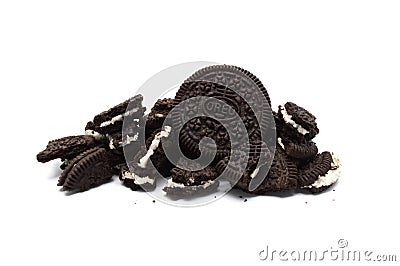 Oreo Biscuits with cracked and crumbs on white background. Pile of a sandwich cookies filled with sweet cream flavored Editorial Stock Photo
