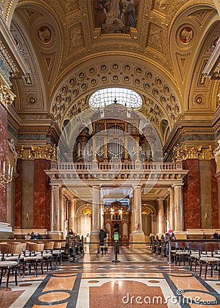 Budapest, Hungary - Feb 8, 2020: Organ pipe facade with golden fresco ceiling in St. Stephen`s Basilica Editorial Stock Photo