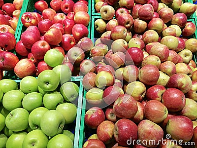 red green yellow apples in fruit crates color composition Stock Photo