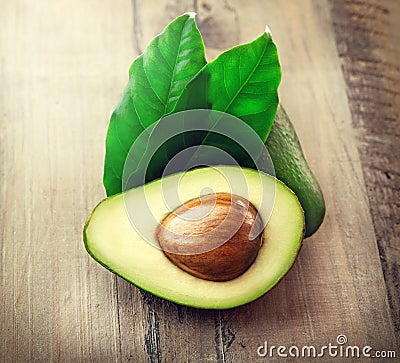 Organic avocado on a wooden table Stock Photo