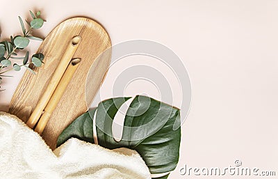 Organic bamboo towel with bamboo branches, on a background with monstera Stock Photo