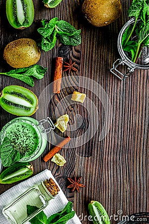 woman cosmetics set with scrub and kiwi table background top view mockup Stock Photo