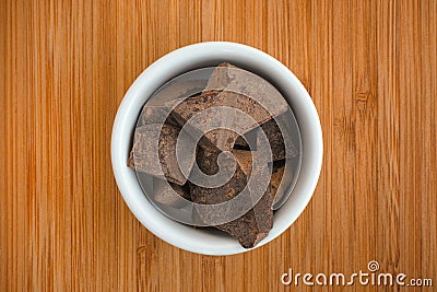 Organic Cacao Paste in a bowl on a wooden background Stock Photo