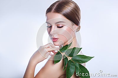 Organic cosmetic . Beautiful woman face portrait with green leaf , concept for skin care or organic cosmetics Stock Photo