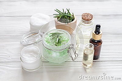 Organic cosmetics with extracts of herbs rosemary on wooden background Stock Photo