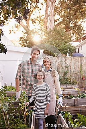 We are an organic family. Portrait of a happy family gardening together in their backyard. Stock Photo