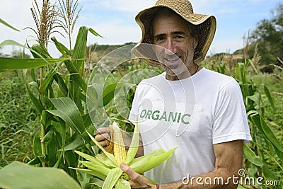 Organic farmer showing corn inside the plantation Stock Photo