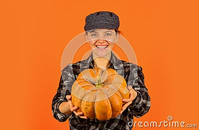 Organic farming. Family farm. Woman rustic farmer presenting pumpkin. Farming and agriculture. Agriculture concept Stock Photo