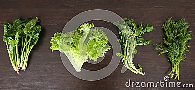 Organic food background. Spring vitamin set of various green leafy vegetables on rustic wooden table. Fresh spinach Stock Photo