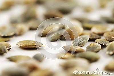 Organic green pumpkin seeds against a white background Stock Photo