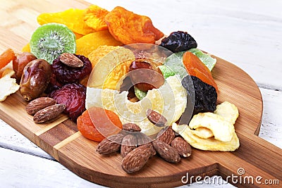 Organic Healthy Assorted Dried Fruit on bamboo wine board. Selective focus. Stock Photo