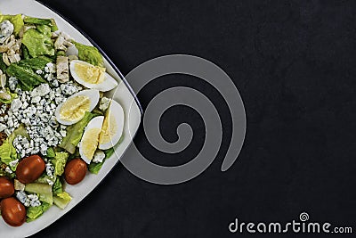 Organic homemade salad. Assorted vegetable salad on black background Stock Photo