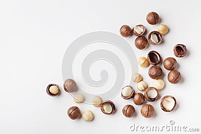 Organic macadamia nuts on white table top view. Stock Photo