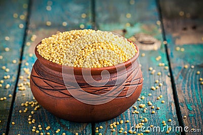 Organic millet seeds in a ceramic bowl Stock Photo