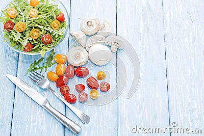 Organic mushrooms. Health food. Fresh mushrooms and arugula salad, cherry tomatoes Stock Photo