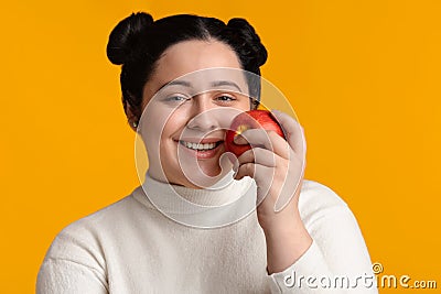 Beautiful Happy Plump Girl Holding Red Apple And Sincerely Smiling Stock Photo