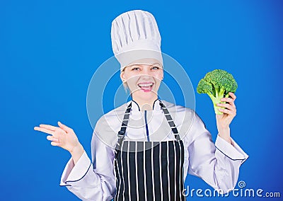 Organic nutrition. Woman chef hold broccoli pointing at copy space. Healthy vegetarian recipes. Amazing broccoli facts Stock Photo