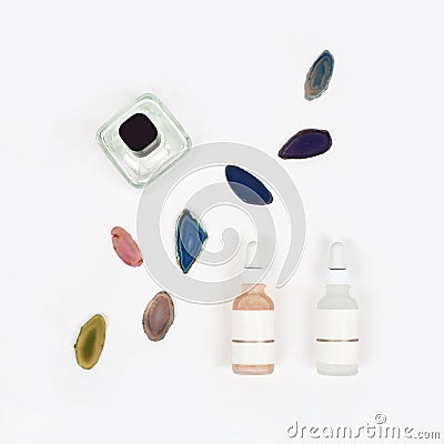 Organic pharmacy cosmetics with natural agate stone on white background. Flat lay. Top view of bottles of cream. Natural beauty Stock Photo