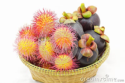 Organic rambutan and mangosteen Thai fruits in wicker basket. Stock Photo