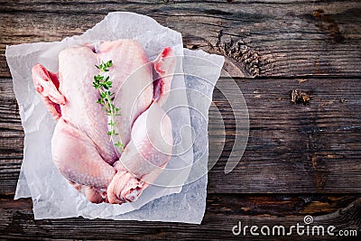 Organic raw whole chicken on wooden background Stock Photo