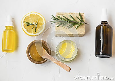 Organic skincare ingredients with manuka honey, lemon, rosemary, face oil, salve balm , natural soap and face water spray, top Stock Photo