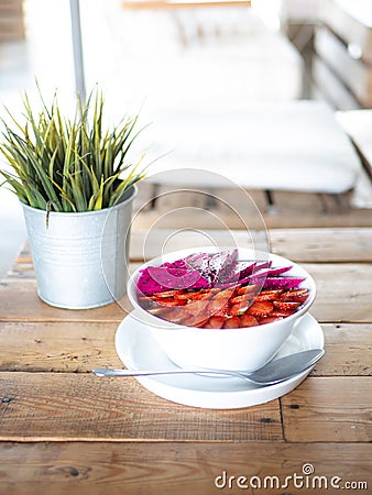 Organic Smoothie Bowl with Fresh Fruit on Wooden Table with Bright Light Stock Photo