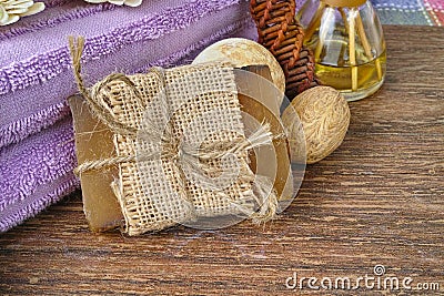 Organic soap, purple sauna towel and decoration on walnut tree background,layout with free text space Stock Photo