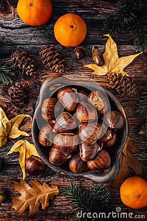 Organic sweet chestnuts in a bowl on kitchen table Stock Photo