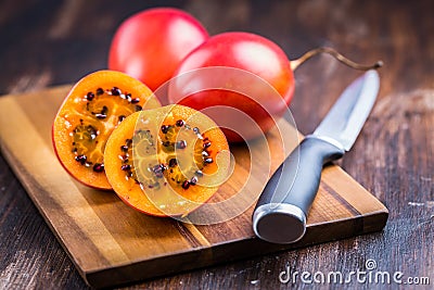 Organic tamarillo tree tomato on cutting board Stock Photo