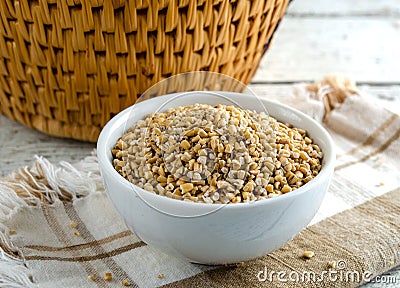 Organic Uncooked Steel Cut Oats in bowl on napkin. Also know as pinhead oats and Irish oats. Stock Photo