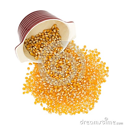 Organic yellow popcorn spilling from dish Stock Photo