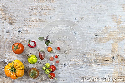 Organically grown ancient variety of tomatoes on old white wooden table with copy space Stock Photo