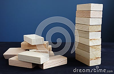 Organization, strategy and risk in business. Tower and piled up from wooden bricks Stock Photo