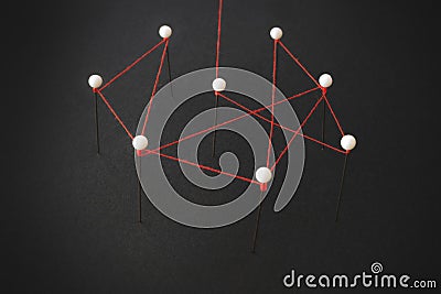 Organizational structure or social network concept with pins and thread illustrating linkages Stock Photo