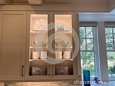 Organized glass cabinets in the kitchen of a luxury vacation rental home on Kiawah Island in South Carolina Editorial Stock Photo