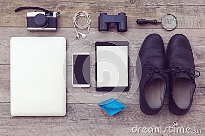 Organized modern and retro objects on wooden table. Adventure essentials for man Stock Photo