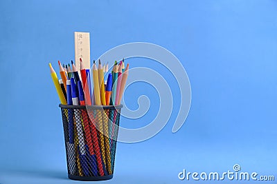 Organizer with pencils and ruler, stand for stationery form bucket blue background. Stock Photo