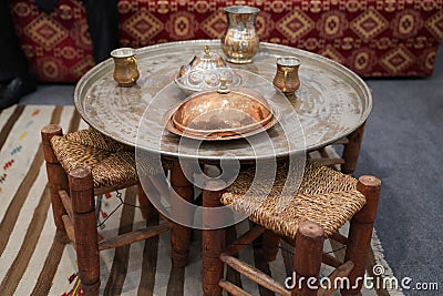 Oriental copper tray with chairs to eat meal or enjoy tea time Stock Photo