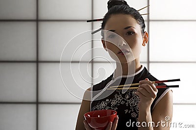 Oriental girl with chopstick Stock Photo