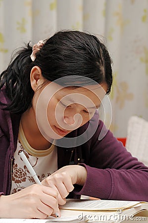 Oriental girl on writing Stock Photo