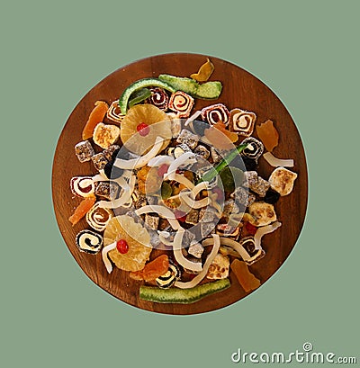 Oriental Sweets.Close up of Turkish delight and succades on wooden plate on light green. Top view. Dessert Stock Photo