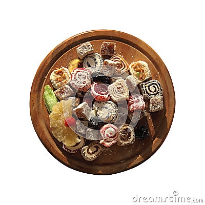 Oriental Sweets. Close up of Turkish delight and succades on wooden plate isolated on white. Top view. Dessert Stock Photo