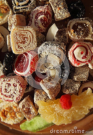 Oriental Sweets. Close up of Turkish delight and succades on wooden plate. Top view. Dessert background Stock Photo