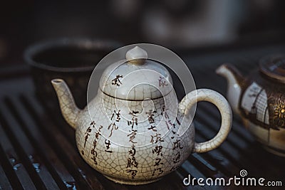 Oriental traditional teapot with characters Stock Photo